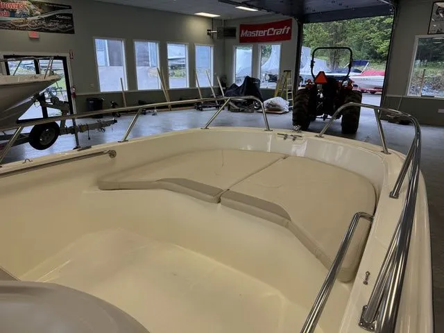 Slide: The Image of 2025 Boston Whaler 160 Super Sport boat interior in showroom with MasterCraft banner. - 14