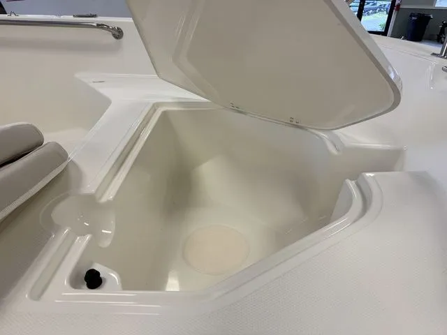 Slide: The Image of 2025 Boston Whaler 160 Super Sport storage compartment with open lid, showcasing interior space. - 15