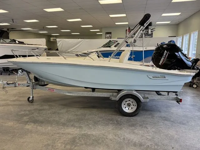 Slide: The Image of 2025 Boston Whaler 160 Super Sport boat on trailer in showroom. - 2