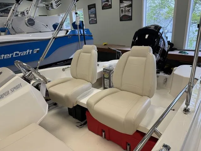 Slide: The Image of 2025 Boston Whaler 160 Super Sport interior with beige seats and modern design. - 9