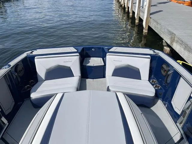Slide: The Image of 2024 MasterCraft ProStar boat interior with sleek seating, dockside view. - 10