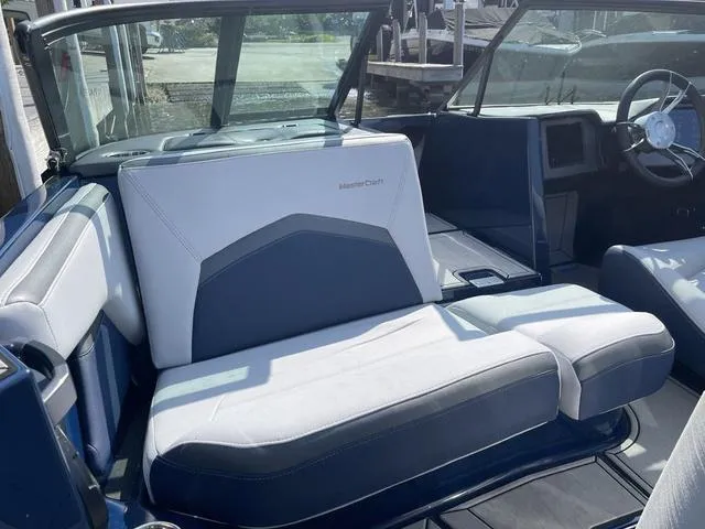 Slide: The Image of 2024 MasterCraft ProStar interior with blue and white seating, showcasing modern design and comfort. - 12