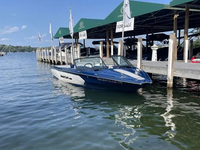 Slide: The Image of 2024 MasterCraft ProStar boat docked, for sale at marina under green canopy. - 3