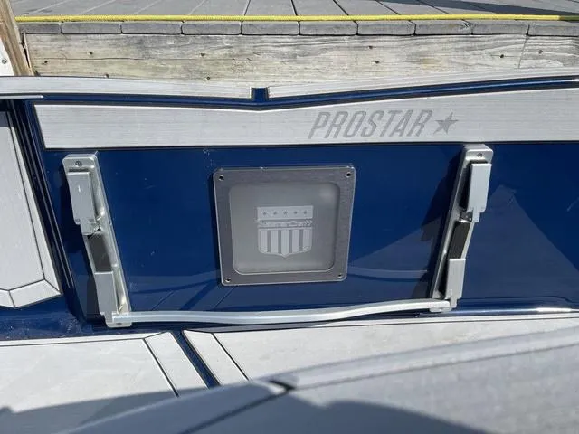 Slide: The Image of 2024 MasterCraft ProStar boat stern with logo and dock background. - 9