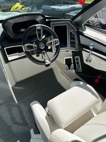 Slide: The Image of 2023 MasterCraft X24 boat cockpit with modern steering and controls. - 10
