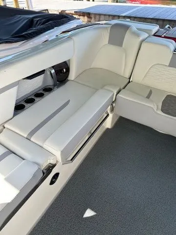 Slide: The Image of 2023 MasterCraft X24 boat interior with white seating and cup holders. - 13