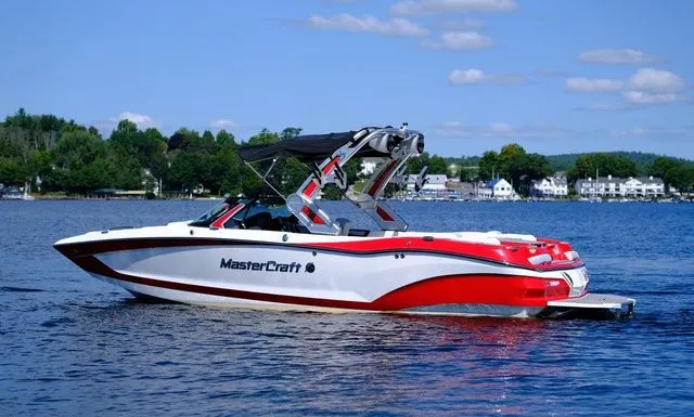 Slide: The Image of 2023 MasterCraft X24 boat on a lake with scenic background. - 5
