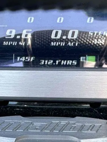 Slide: The Image of Close-up of 2014 Malibu Wakesetter 23 LSV dashboard displaying 312.7 hours and 145°F temperature. - 10