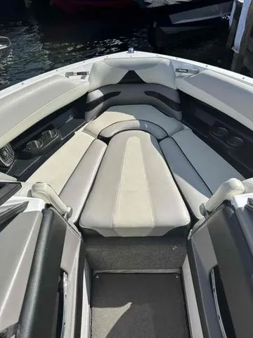 Slide: The Image of 2014 Malibu Wakesetter 23 LSV boat interior with cushioned seating and cup holders. - 2