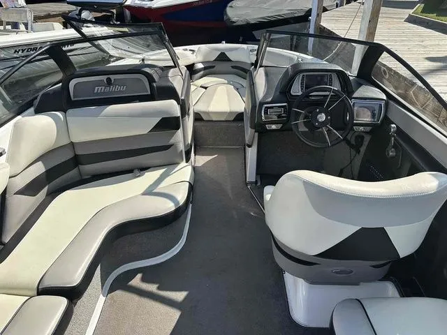 Slide: The Image of 2014 Malibu Wakesetter 23 LSV interior with sleek seating and modern dashboard design. - 6