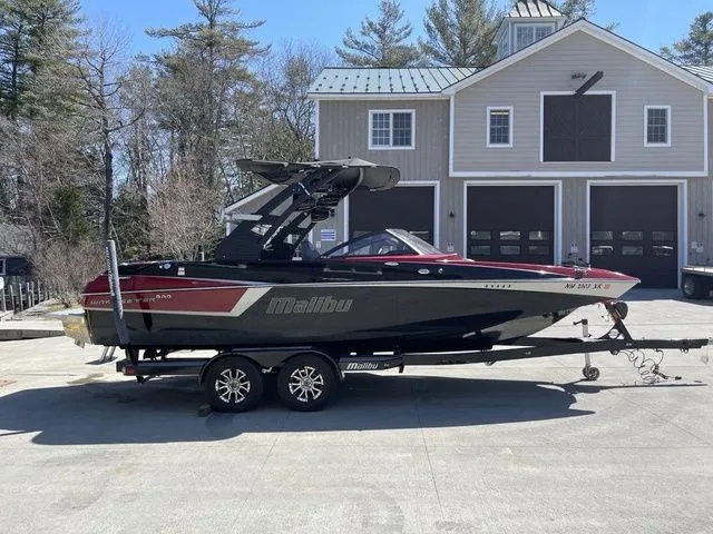 Slide: The Image of 2017 Malibu 22 MXZ boat with new engine and transmission, parked on a trailer. - 1