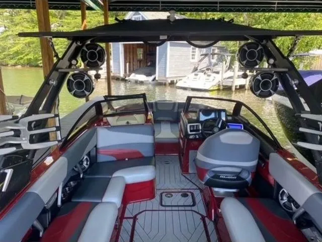 Slide: The Image of 2017 Malibu 22 MXZ boat interior with new engine and transmission, docked by a lakeside. - 10