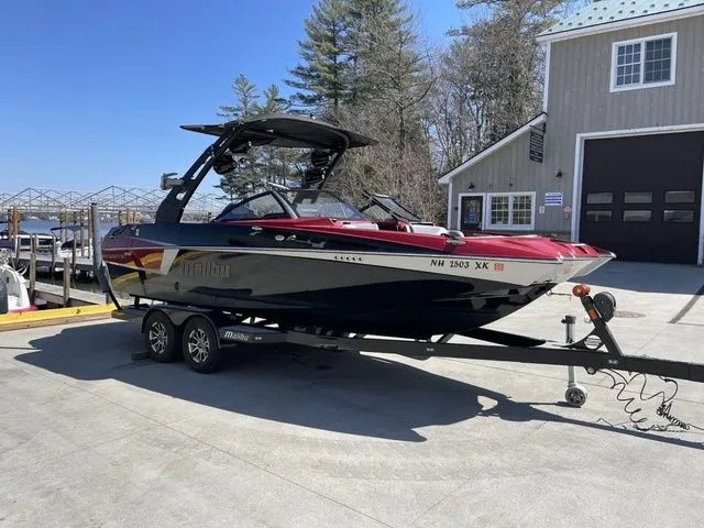 Slide: The Image of 2017 Malibu 22 MXZ boat with new engine and transmission on a trailer, parked outdoors. - 3
