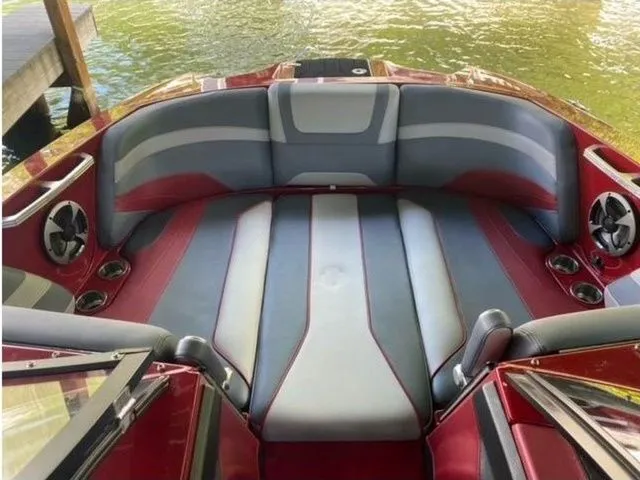 Slide: The Image of 2017 Malibu 22 MXZ boat interior with red and gray seating, new engine and transmission. - 7