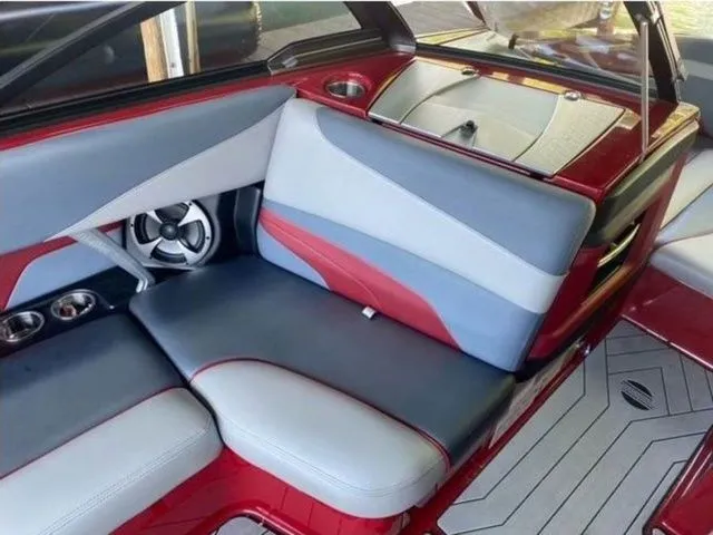 Slide: The Image of 2017 Malibu 22 MXZ boat interior with red and gray seating, featuring new engine and transmission. - 8