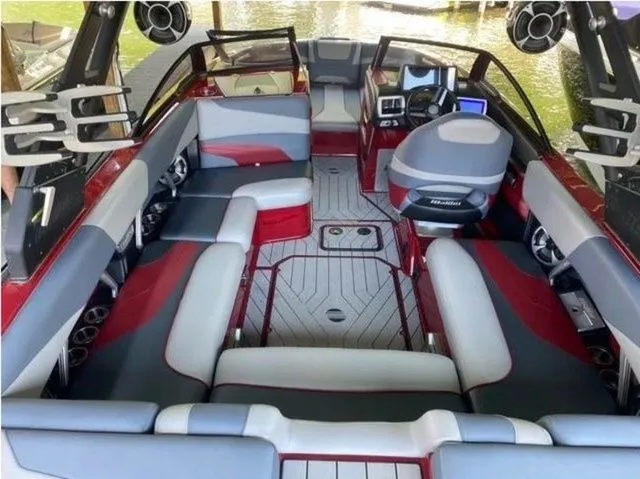 Slide: The Image of 2017 Malibu 22 MXZ boat interior with new engine and transmission, featuring spacious seating and modern design. - 9