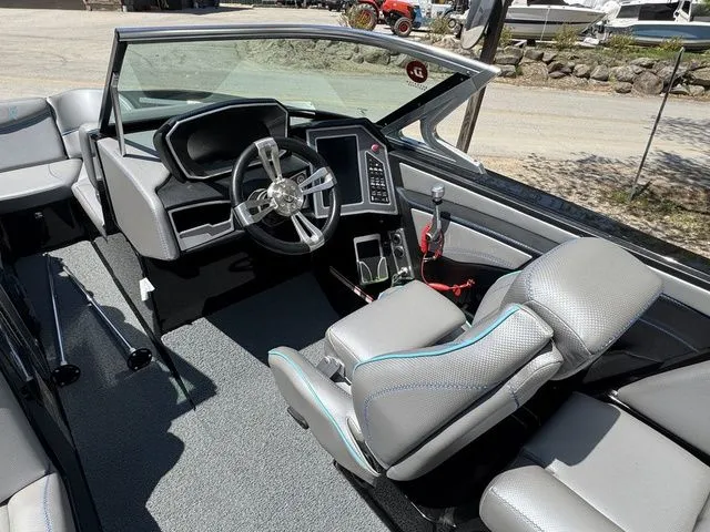 Slide: The Image of 2018 MasterCraft X23 boat interior with modern dashboard and seating. - 13