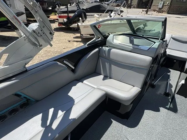 Slide: The Image of 2018 MasterCraft X23 boat interior with gray seating and open deck view. - 15