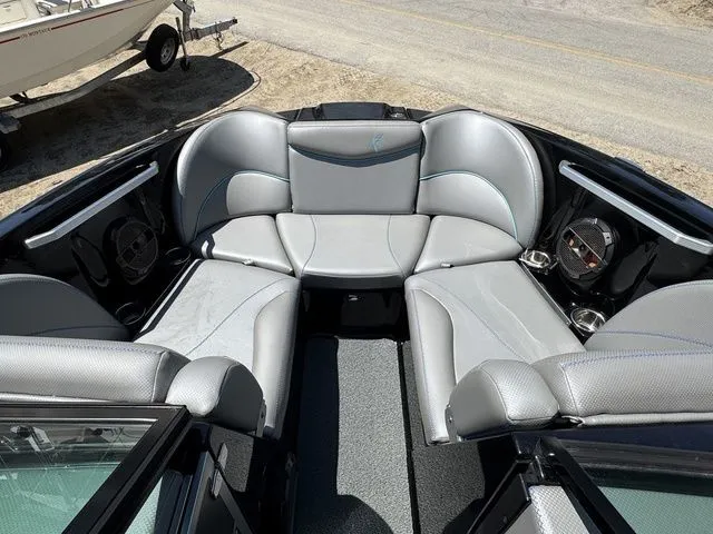 Slide: The Image of 2018 MasterCraft X23 boat interior with gray seating and cup holders. - 16