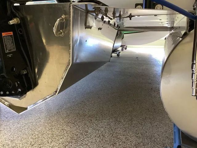 Slide: The Image of 2025 Premier 200 SUNSCAPE RE-CL pontoon boat underside view in a garage. - 7