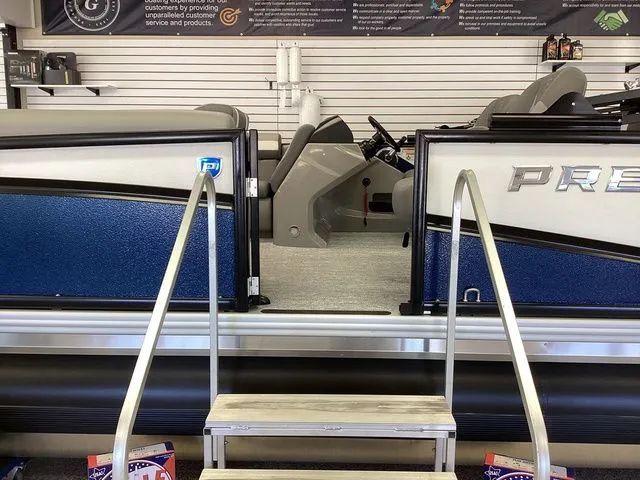 Slide: The Image of 2025 Premier 200 SUNSCAPE RE-CL pontoon boat interior with entry steps in showroom. - 9