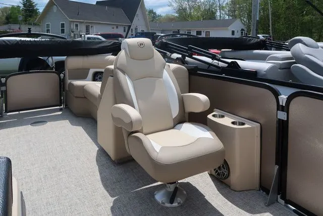 Slide: The Image of 2024 Premier 230 Solaris RF boat interior with beige seating and cup holders. - 10