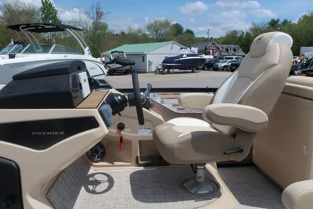 Slide: The Image of 2024 Premier 230 Solaris RF boat interior with captain's chair and control panel. - 11