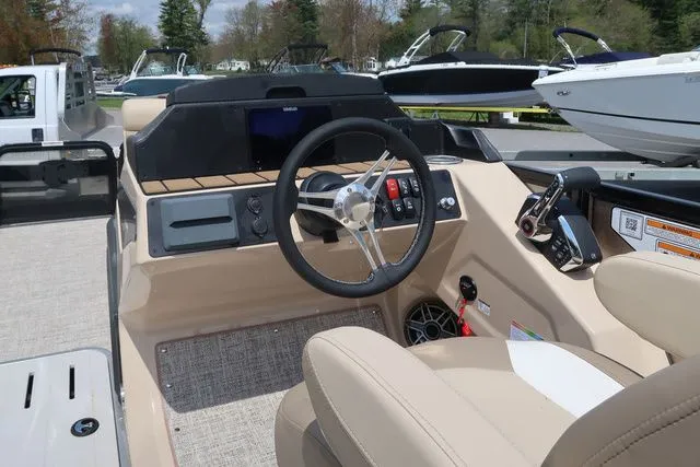 Slide: The Image of 2024 Premier 230 Solaris RF boat cockpit with steering wheel and control panel. - 12
