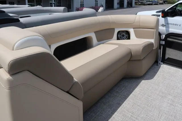 Slide: The Image of 2024 Premier 230 Solaris RF boat interior with beige seating and speaker. - 14