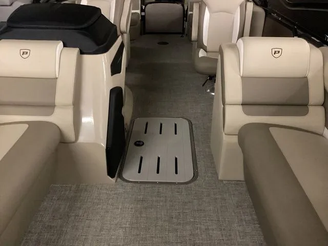 Slide: The Image of 2024 Premier 230 Solaris RF interior with beige seating and carpeted flooring. - 17
