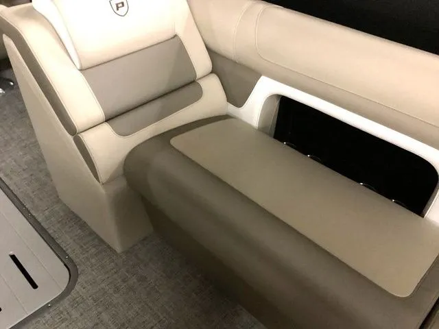Slide: The Image of 2024 Premier 230 Solaris RF boat interior with beige seating and storage compartment. - 19