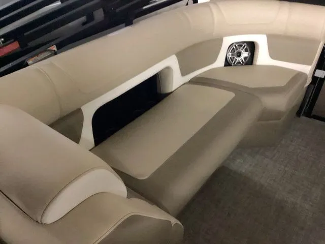 Slide: The Image of 2024 Premier 230 Solaris RF boat interior with beige seating and built-in speaker. - 21