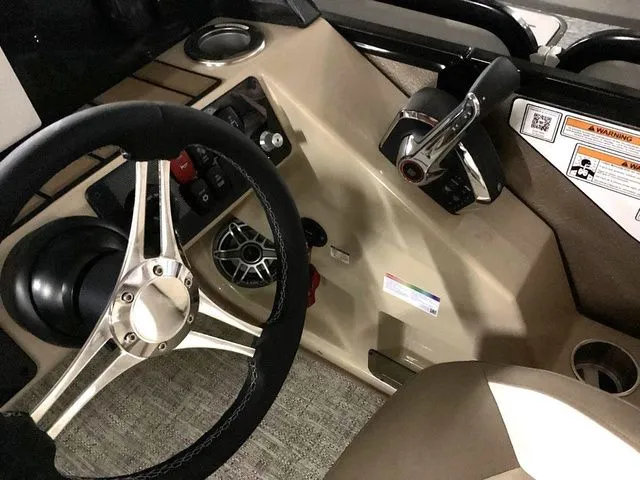 Slide: The Image of 2024 Premier 230 Solaris RF boat dashboard with steering wheel and controls. - 22