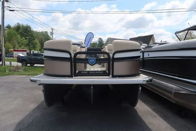 Slide: The Image of 2024 Premier 230 Solaris RF pontoon boat, rear view, parked outdoors. - 3
