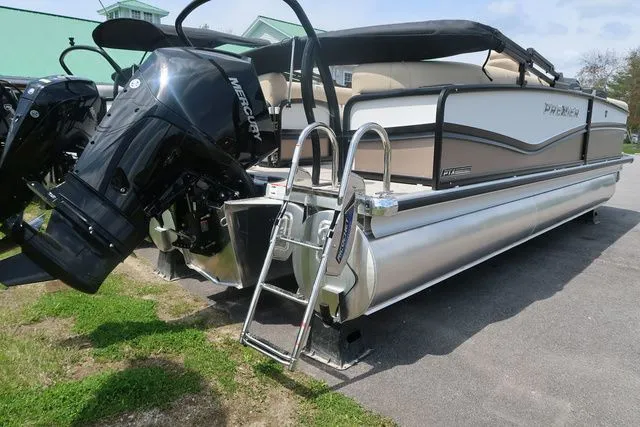 Slide: The Image of 2024 Premier 230 Solaris RF pontoon boat with Mercury outboard engine, docked on pavement. - 6