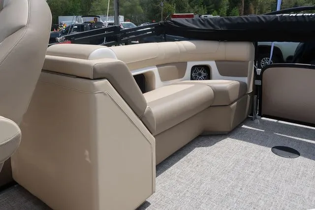 Slide: The Image of Luxurious seating on 2024 Premier 230 Solaris RF boat, featuring beige upholstery and integrated speaker. - 8