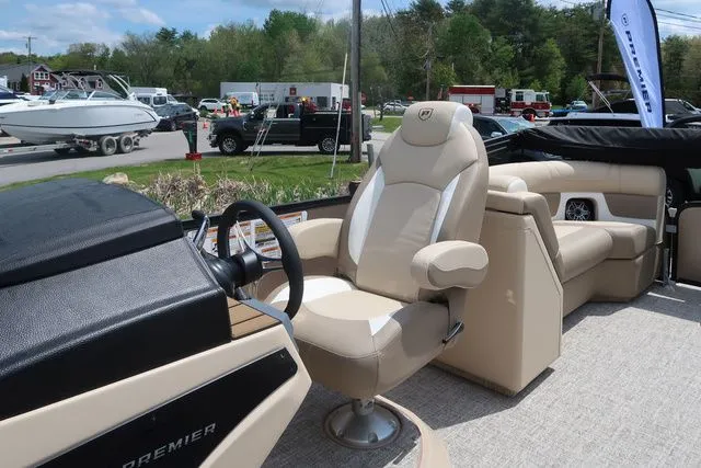 Slide: The Image of 2024 Premier 230 Solaris RF boat interior with beige seating and steering wheel. - 9