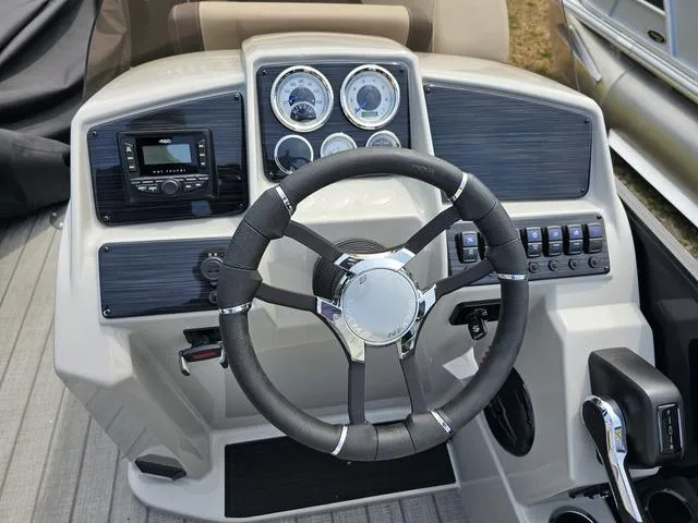 Slide: The Image of 2025 Sylvan Mirage 8520 CLZ DH boat dashboard with steering wheel and control panel. - 13