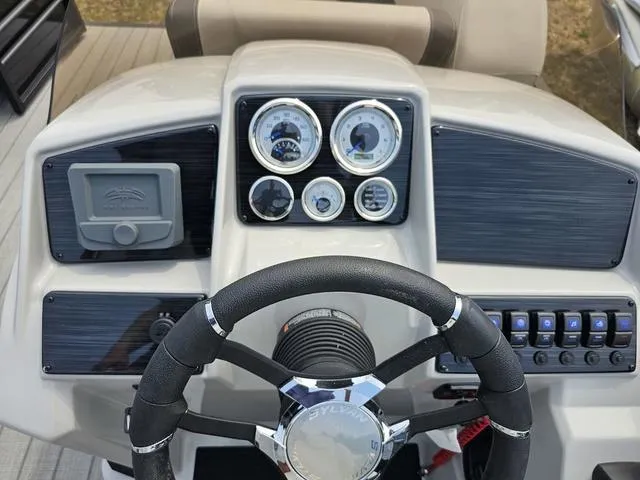 Slide: The Image of Steering console of 2025 Sylvan Mirage 8520 CLZ DH pontoon boat with gauges and controls. - 7