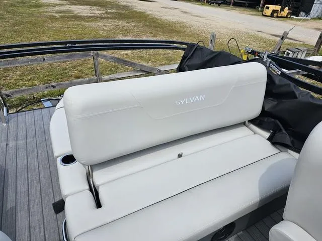 Slide: The Image of 2025 Sylvan Mirage 8520 CLZ DH boat with white seating on deck. - 8