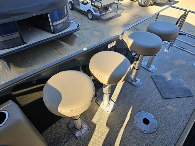 Slide: The Image of 2025 Sylvan MIRAGE X3 DLZ BAR boat with bar stools on deck. - 12