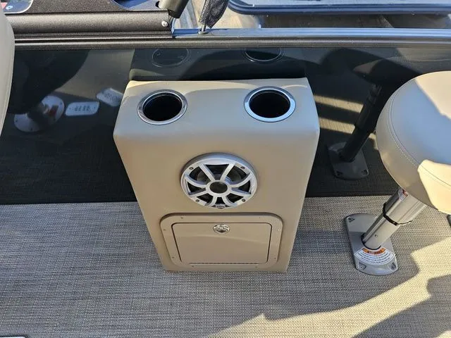 Slide: The Image of 2025 Sylvan MIRAGE X3 DLZ BAR boat interior with speaker and cup holders. - 13