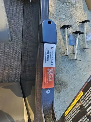 Slide: The Image of SureShade component on 2025 Sylvan MIRAGE X3 DLZ BAR boat, outdoor setting. - 14