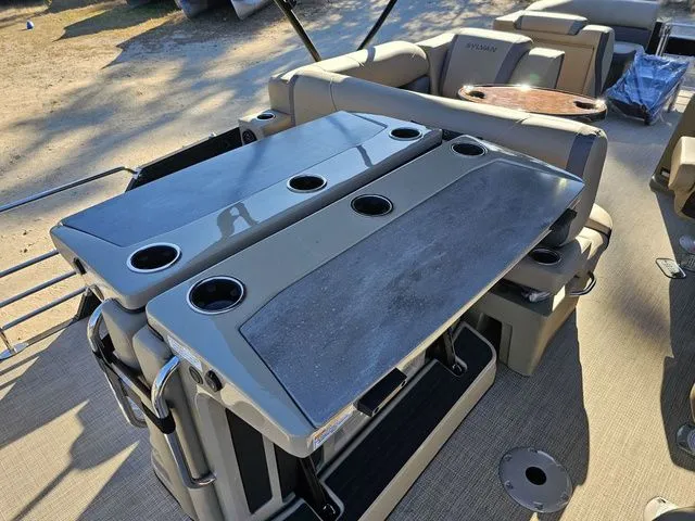 Slide: The Image of 2025 Sylvan MIRAGE X3 DLZ BAR pontoon boat with foldable bar tables and cup holders. - 15