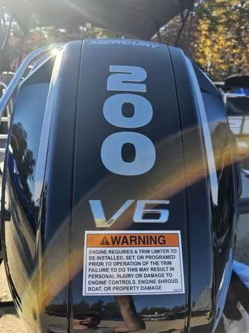 Slide: The Image of Outboard motor with "200 V6" label and warning sticker on a 2025 Sylvan MIRAGE X3 DLZ BAR. - 3