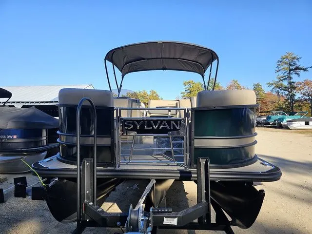 Slide: The Image of 2025 Sylvan MIRAGE X3 DLZ BAR pontoon boat with canopy, parked outdoors. - 5