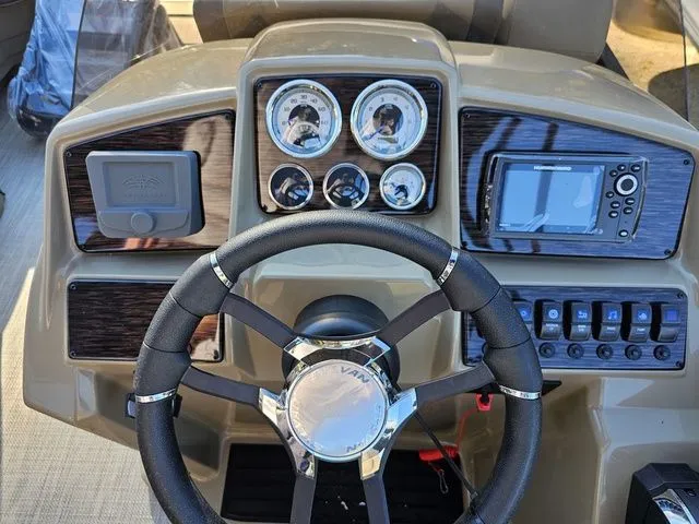 Slide: The Image of Dashboard of 2025 Sylvan MIRAGE X3 DLZ BAR boat with steering wheel and gauges. - 9