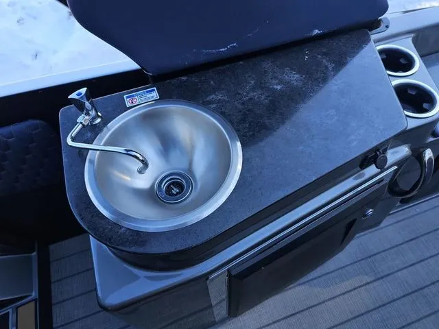 Slide: The Image of Compact sink and countertop on 2025 Sylvan M3 CLZ DC boat, featuring cup holders and sleek design. - 21