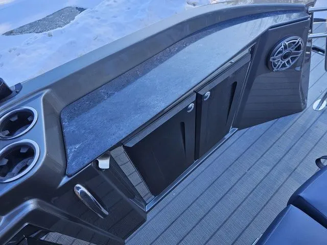 Slide: The Image of 2025 Sylvan M3 CLZ DC boat console with cup holders and storage compartments. - 22