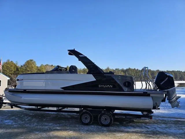 Slide: The Image of 2025 Sylvan M3 CLZ DC pontoon boat on trailer, parked outdoors. - 3
